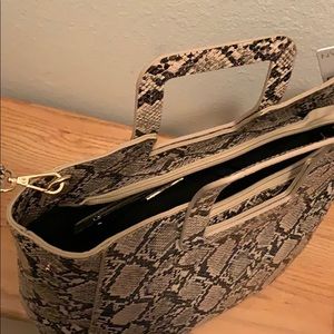 A vegan/faux leather cross body snakeskin bag